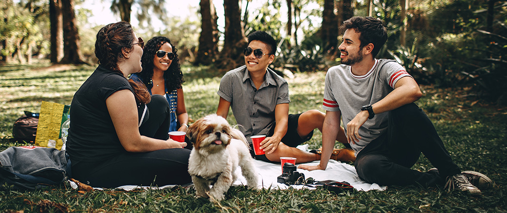 5 People - friends having a picnic outside with dog