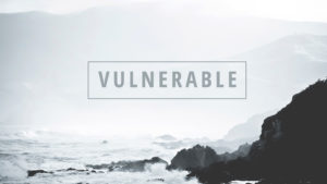 Vulnerable cover - foggy sky over ocean with waves breaking on cliffs
